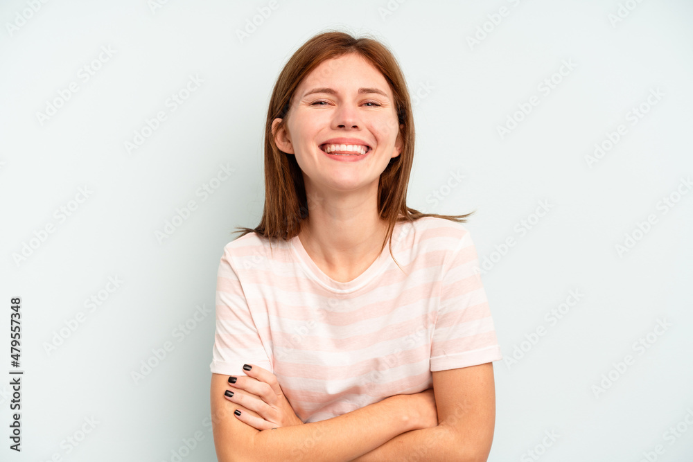 Young English woman isolated on blue background laughing and having fun. Young English woman isolated on blue background laughing and having fun.