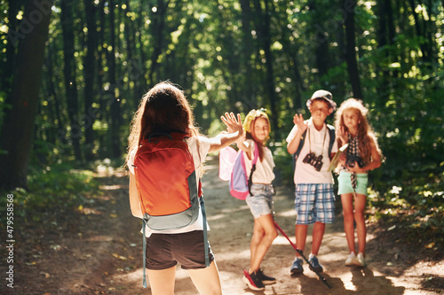 Ready for adventure. Kids strolling in the forest with travel equipment