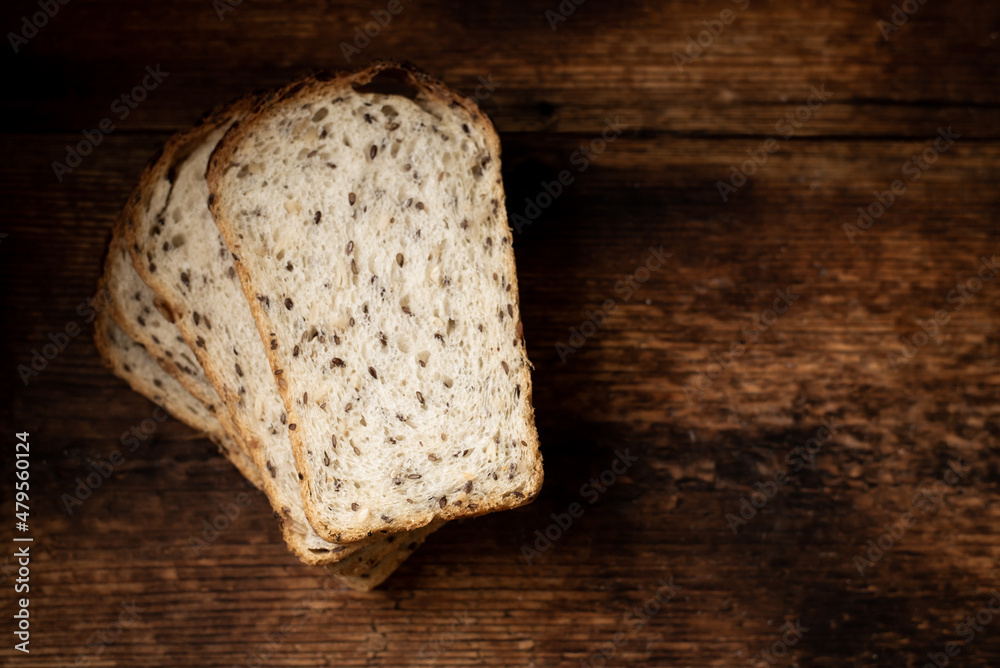 Pieces of bread with seeds on a wooden background. Healthy, healthy bread. Healthy food. Place for your text.