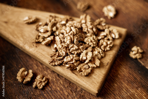 Peeled walnuts. On a wooden background. Healthy food. Natural background.