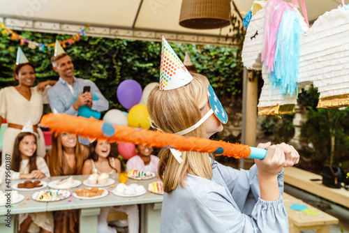 White girl breaking toy unicorn during birthday party