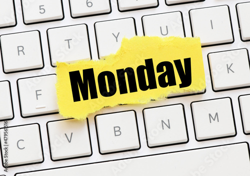 MONDAY on a small yellow sheet of paper lay on the keyboard.