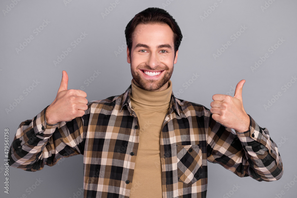 Photo of funky charming man wear plaid shirt showing two thumbs up isolated grey color background