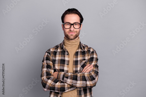 Photo of clever charming man wear plaid shirt spectacles arms crossed isolated grey color background