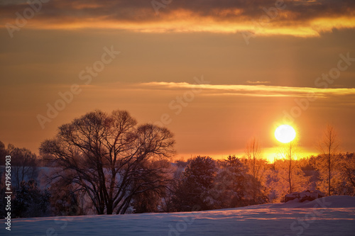 sunset in cold winter morning in country side with snow
