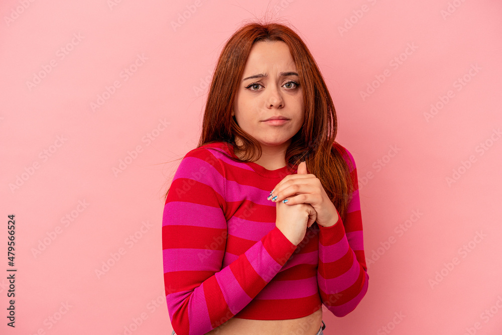 Young caucasian woman isolated on pink background scared and afraid. Young caucasian woman isolated on pink background scared and afraid.