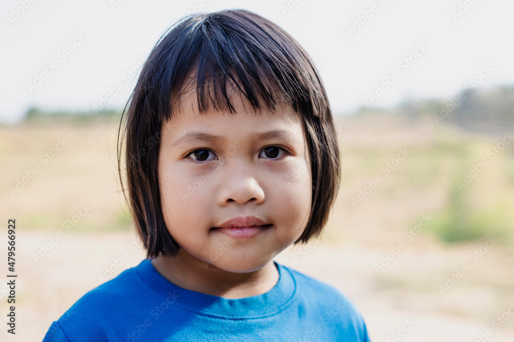 Close up photo of cute little Asian girl in the countryside of Thailand. Close up photo of cute little Asian girl in the countryside of Thailand.