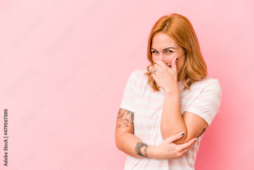 Young caucasian woman isolated on pink background laughing happy, carefree, natural emotion. Young caucasian woman isolated on pink background laughing happy, carefree, natural emotion.