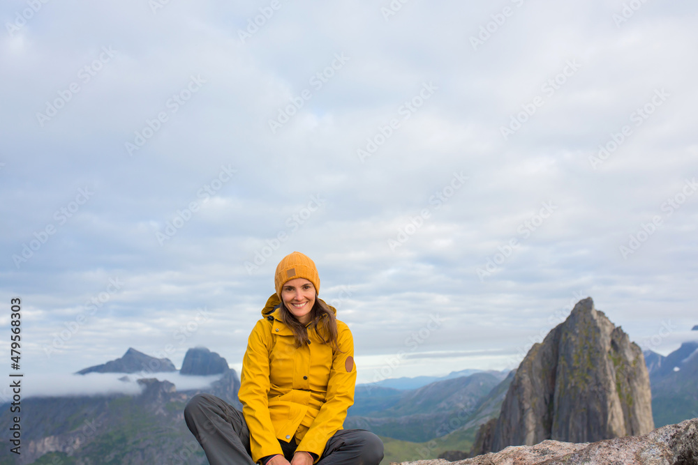 Happy family, standing on a rock and looking over Segla mountain on Senja island, North Norway. Amazing beautiful landscape and splendid nature