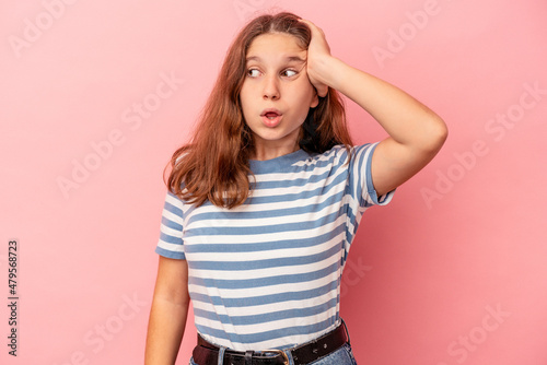 Little caucasian girl isolated on pink background being shocked, she has remembered important meeting.