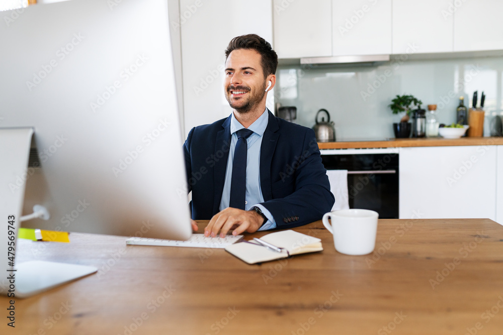 Businessman in suit working at home on computer Businessman in suit working at home on computer