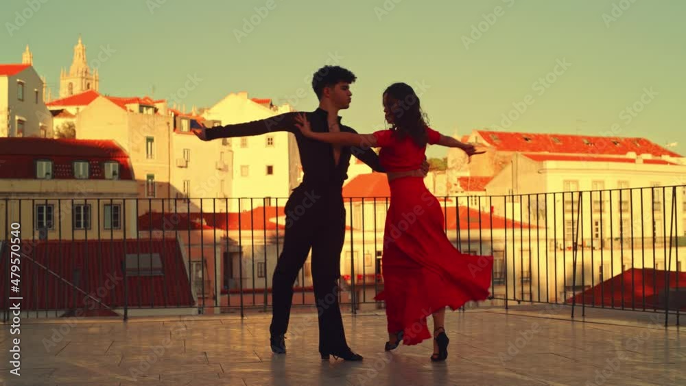 Beautiful Couple Dancing a Latin Dance Outside the City with Old Town in the Background. Sensual Dance by Two Professional Dancers on a Sunset in Ancient Culturally Rich Tourist Location.