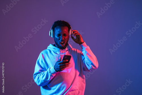 Black man dancing and singing while listening music