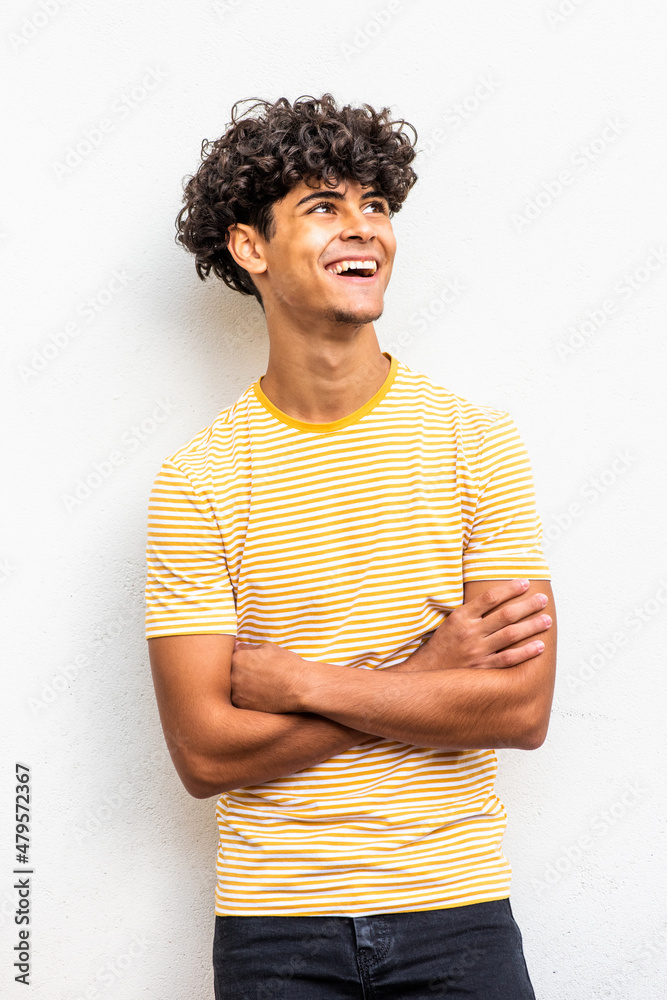 happy teenage boy with arms crossed and looking up happy teenage boy with arms crossed and looking up