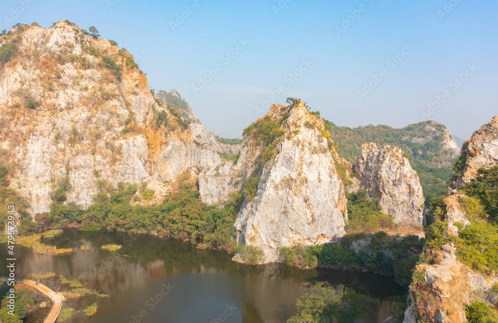 Aerial view of Khao Ngu Stone. National park with river lake, mountain valley hills, and tropical green forest trees at sunset in Ratchaburi, Thailand in travel trip. Natural landscape background.