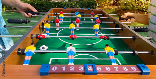 Two kicker game players have fun for playing table football soccer, Soccer table game or Football game toy in the park, photo