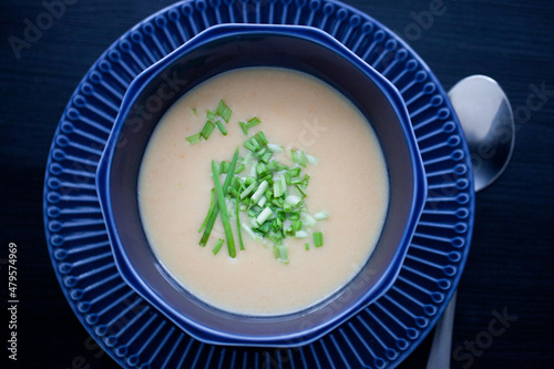 creamy chicken soup puree in a dark blue bowl top view