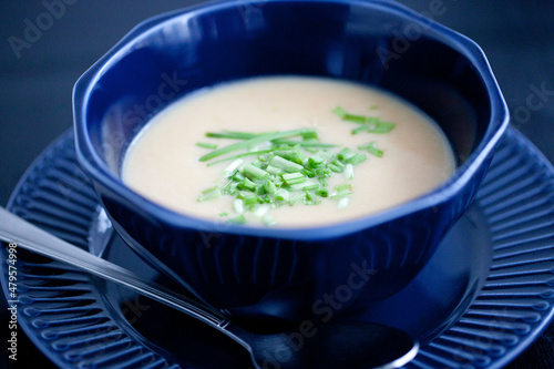 creamy chicken soup puree in a dark blue bowl 