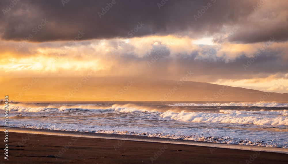 Azores islands, beach with amazing waves and colors, sunset.