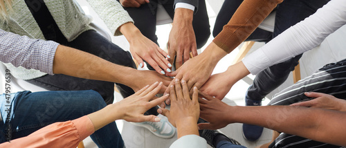 Narrow banner of multiracial people stack hands motivated for shared business success or goal achievement. Diverse intentional employees involved in teambuilding activity. Teamwork, cooperation.