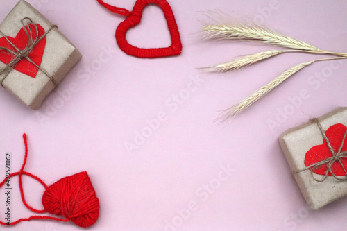 Craft gift box with red heart and craft ribbon on pink background. For celebrate. Valentines day conception.