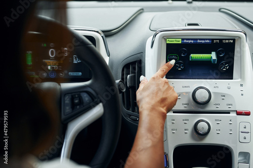 Close up view of front control panel. Woman in casual clothes is sitting in her automobile at daytime © standret