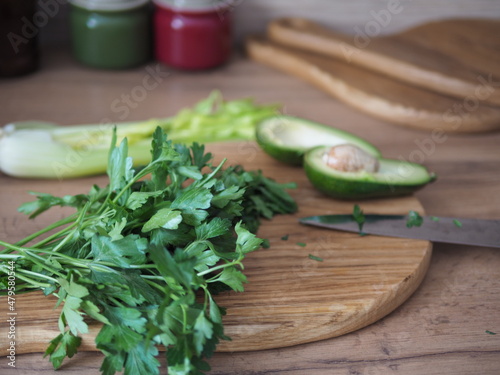 Healthy food concept. Fresh green vegetables on the table  salad  avocado and parsley on a wooden cutting board.