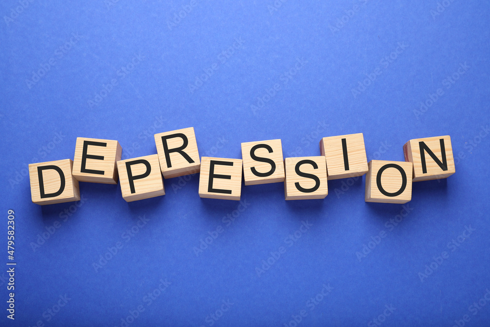 Obraz premium Word Depression made of wooden cubes on blue background, flat lay