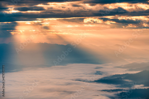 Sunbeam shining through cloudy over Doi Luang Chiang Dao mountain and foggy in the morning