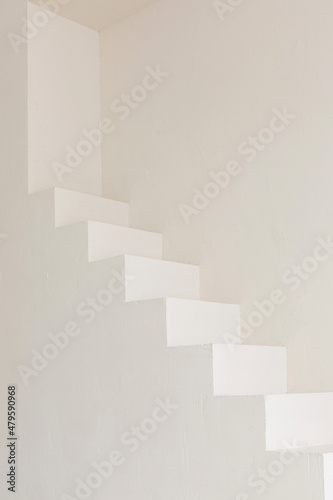 Minimalistic plain staircase along the wall. Light color indoor architecture element. Texture background for business posters. Growth concept.
