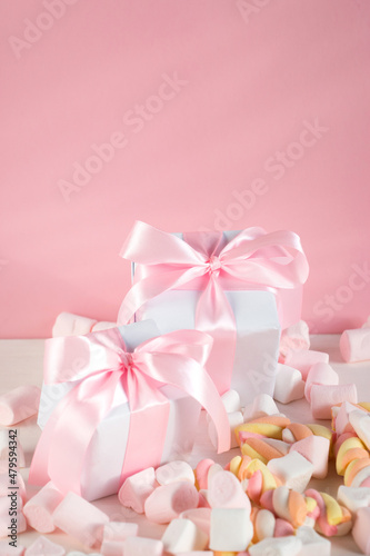 Sweet marshmallows on a pink pastel background. Childhood and birthday concept. © Ekaterina Petrukhan