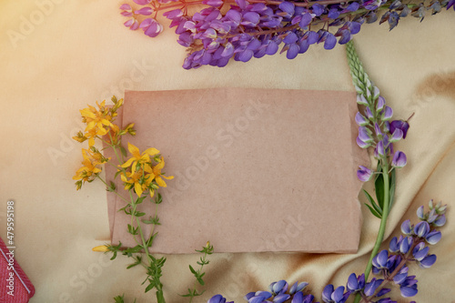 Craft paper mock up. Lupins purple flowers decorations. Natural, wellness closeness to nature. Summer invitation, birthday card, Mother's day concept. Feminine background