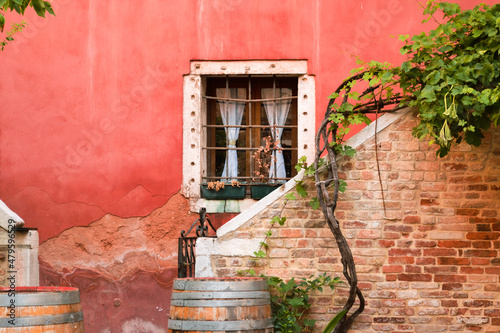 old architecture of italian houses, narrow streets in Venice. lonely window and stairs, village wall