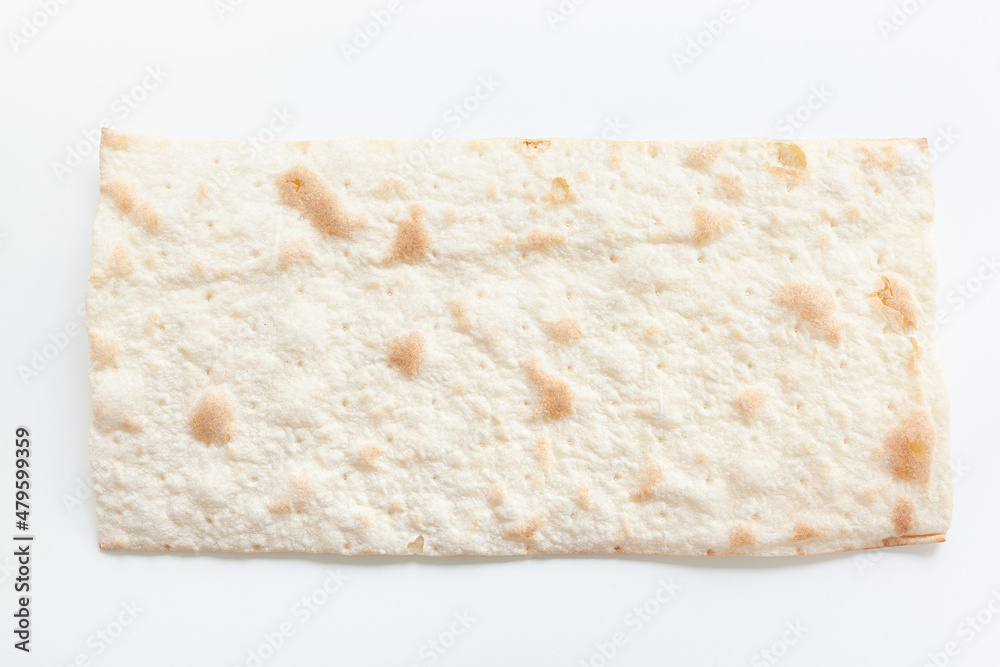 Dry flat bread, toasted, laying flat on white background, Croatian traditional cuisine mlinci