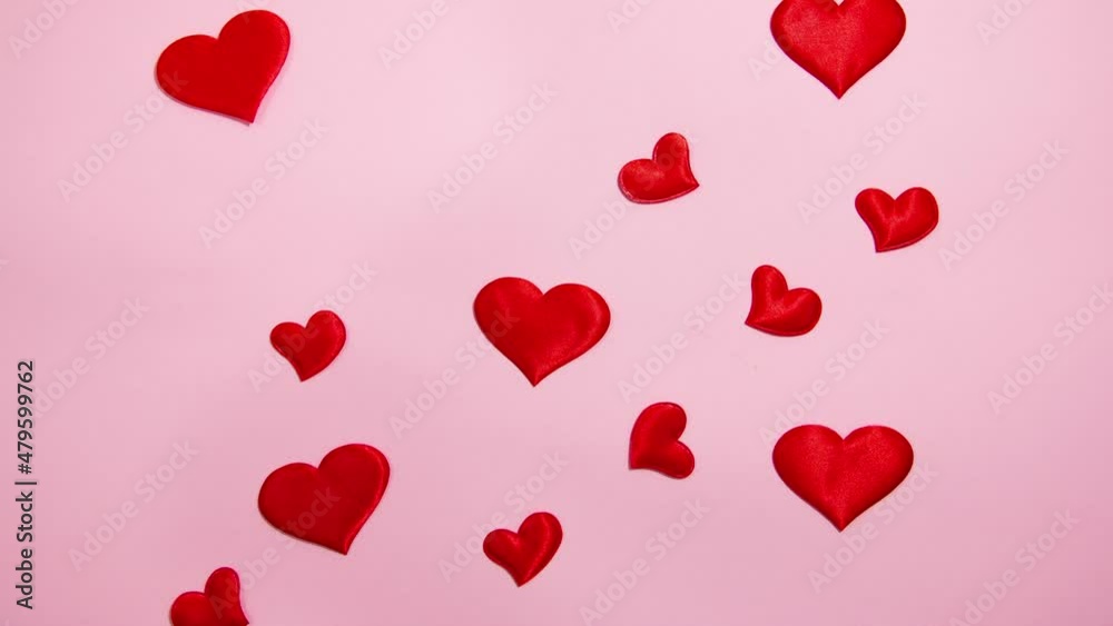 Red hearts on a pink background. Valentine's day concept. Stop motion animation. Red hearts on a pink background. Valentine's day concept. Stop motion animation.