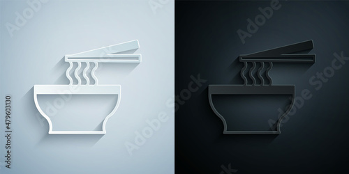 Paper cut Asian noodles in bowl and chopsticks icon isolated on grey and black background. Street fast food. Korean, Japanese, Chinese food. Paper art style. Vector