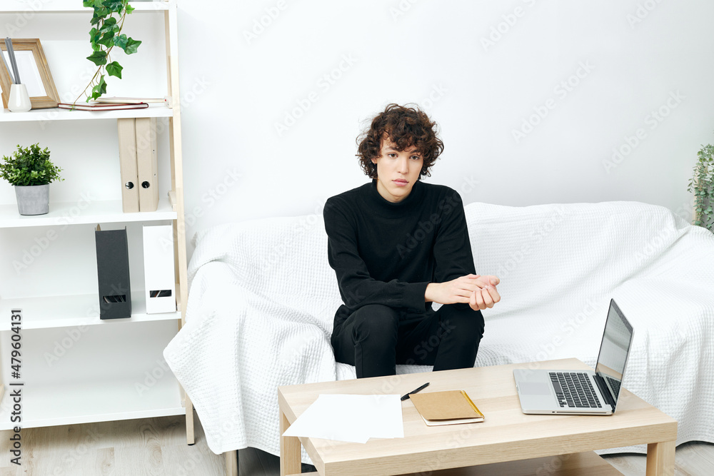 man laptop sitting on white sofa online training communication man laptop sitting on white sofa online training communication