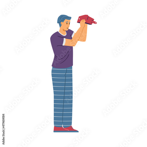 Young male in need of money, isolated, flat vector illustration. Man stands and turns his empty wallet upside down.