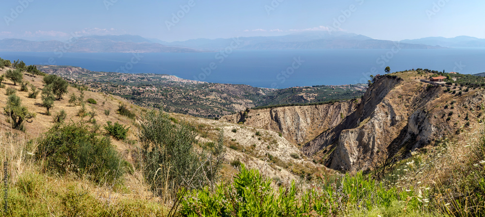 View of the mountains, village and the sea from the cliff (Greece, Peloponnese)