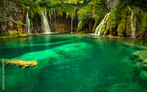 Last sunlight lights up the pure water waterfall on Plitvice National Park. Colorful spring panorama of green forest with blue lake. Great countryside view of Croatia  Europe.