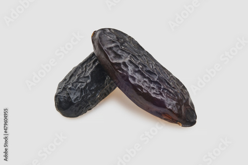 Fragrant tonka beans for baking and cooking on white background. Two Beans of Dipteryx odorata, cumaru or kumaru. Shallow depth of field