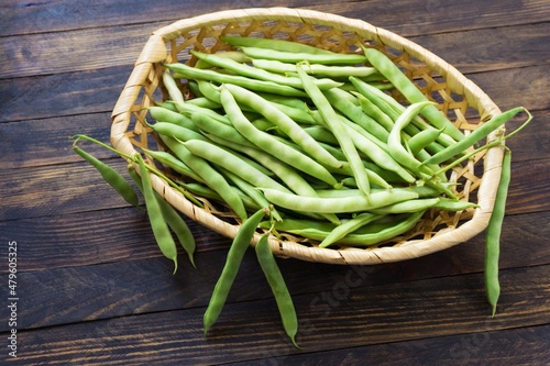 Bean pods in wicker baskets. Kitchen scene in vintage style.