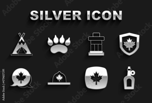 Set Canadian ranger hat, Canada flag on shield, Bottle of maple syrup, leaf, Inukshuk, Indian teepee or wigwam and Bear paw footprint icon. Vector