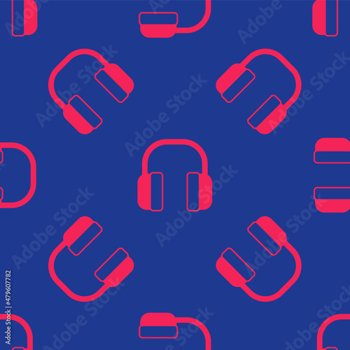 Red Noise canceling headphones icon isolated seamless pattern on blue background. Headphones for ear protection from noise. Vector