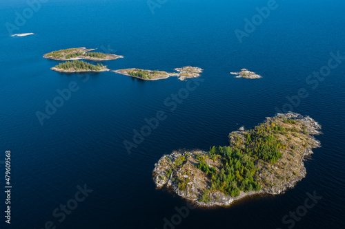 Aerial photography on Ladoga skerries. Ladoga Lake in Karelia in hot summer. Rocky wild islands in the middle of the lake. Russian nature © AndreyZayats