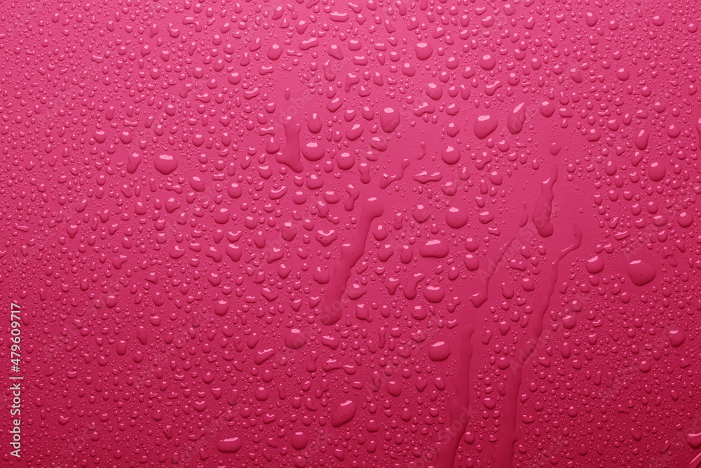 Water drops on pink color surface Water drops on pink color surface