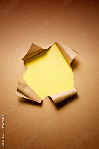 ripped brown paper with blank yellow background