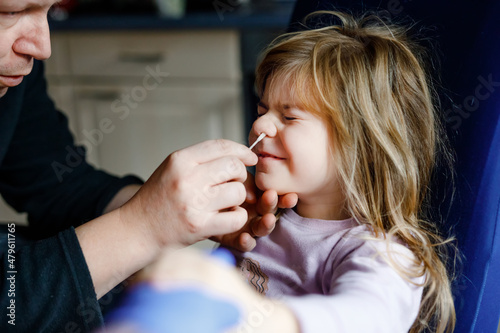 Konstfotografi Father making nasal home corona virus tast to little girl, preschool child