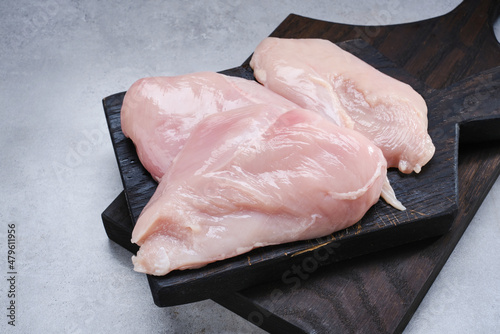 Raw fresh chicken meat. Raw chicken breast on black cutting boards. Selective focus