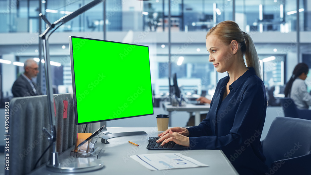 Diverse Modern Office: Confident Businesswoman Using Desktop Computer with Green Screen Mock Up Display. Manager Working on e-Commerce Support, Project Marketing, Data Analysis Diverse Modern Office: Confident Businesswoman Using Desktop Computer with Green Screen Mock Up Display. Manager Working on e-Commerce Support, Project Marketing, Data Analysis